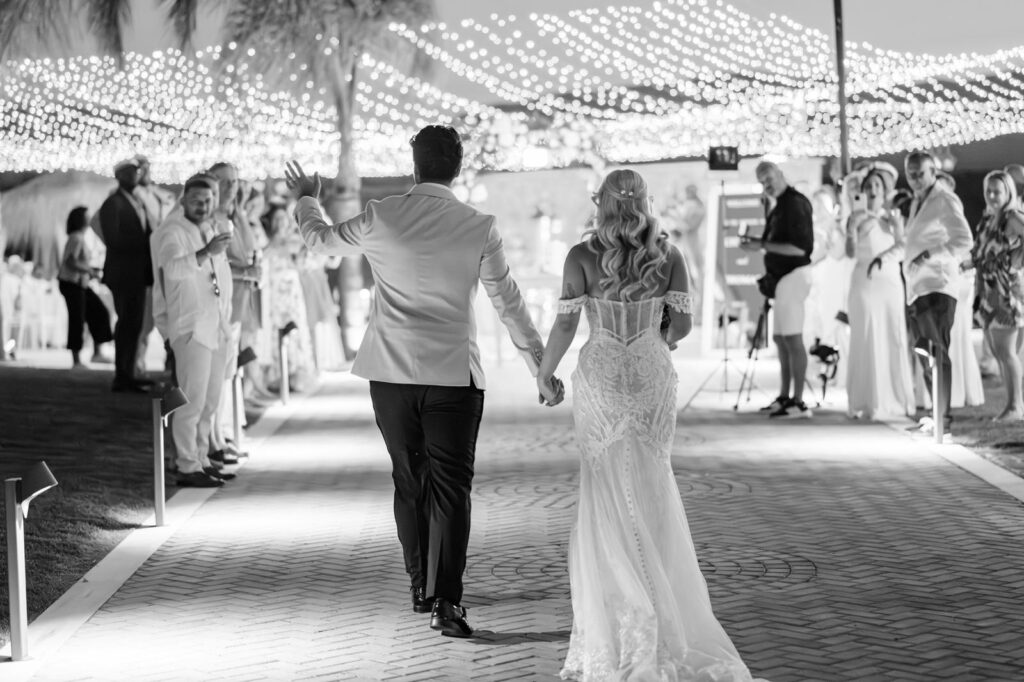 Just married couple walking down a pathway at a luxury villa in Greece
