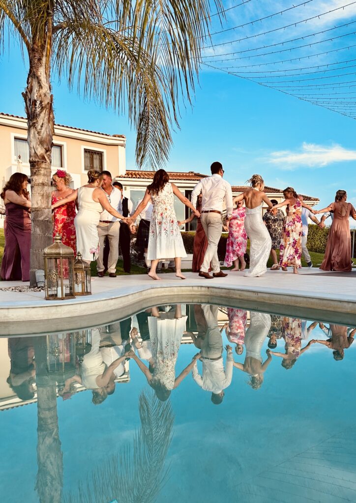 Wedding guest dancing at a pool at a wedding villa in Greece