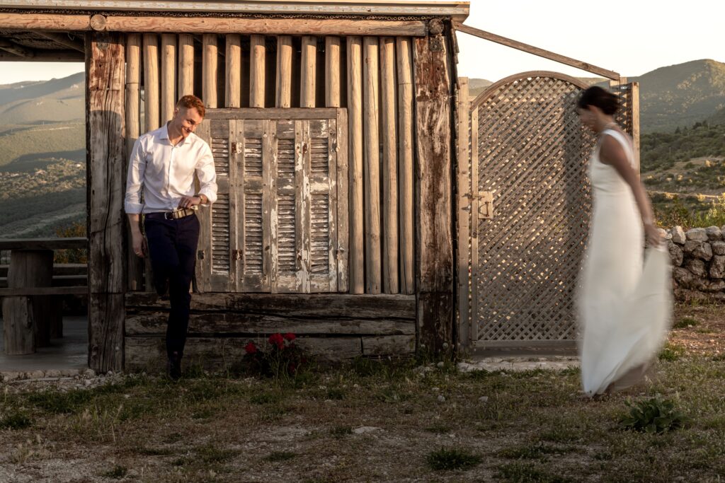 bride and groom at a wooden house in Greece